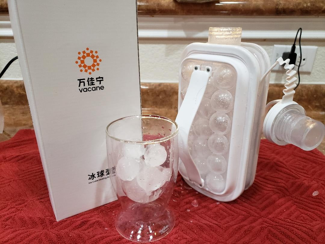 2-in-1 ice ball bottle pouring water after freezing
Pink cocktail with round ice balls and grapefruit slice
Close-up of crystal-like round ice spheres
Two cocktails with rosemary and round ice